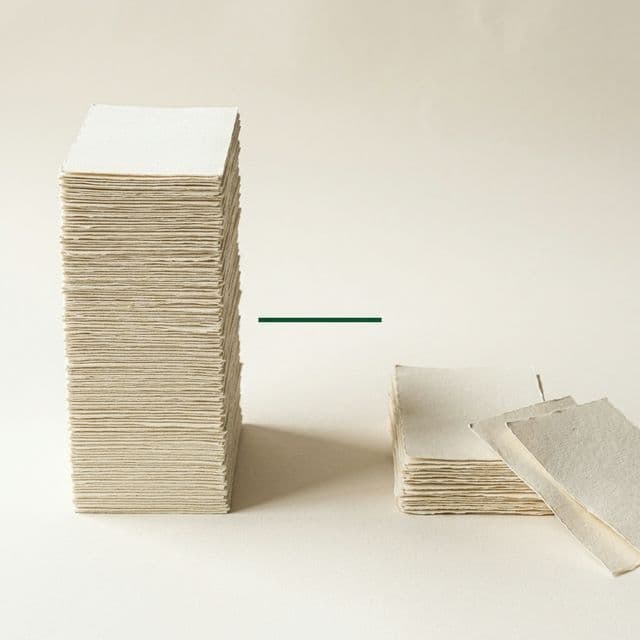 Editorial still-life: two stacks of cream paper representing the 54% vs 12% success rate gap in AI projects